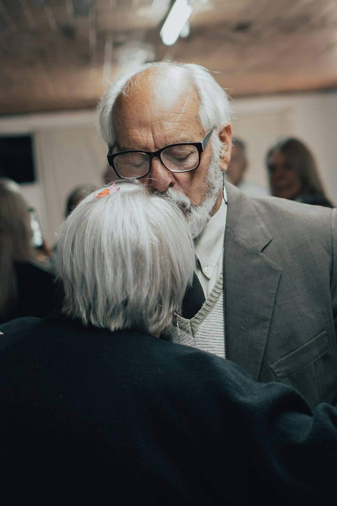Portrait of a man in his fifties with gray hair and glasses in a neutral studio